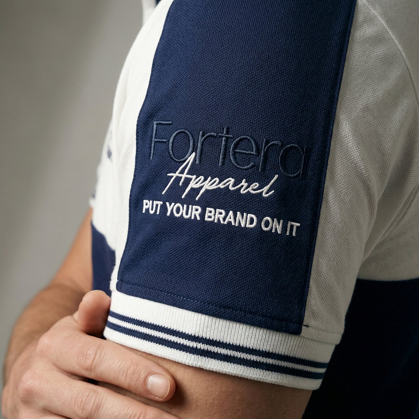 White and navy bulk embroidered polo shirt with bold color block design - team uniform group