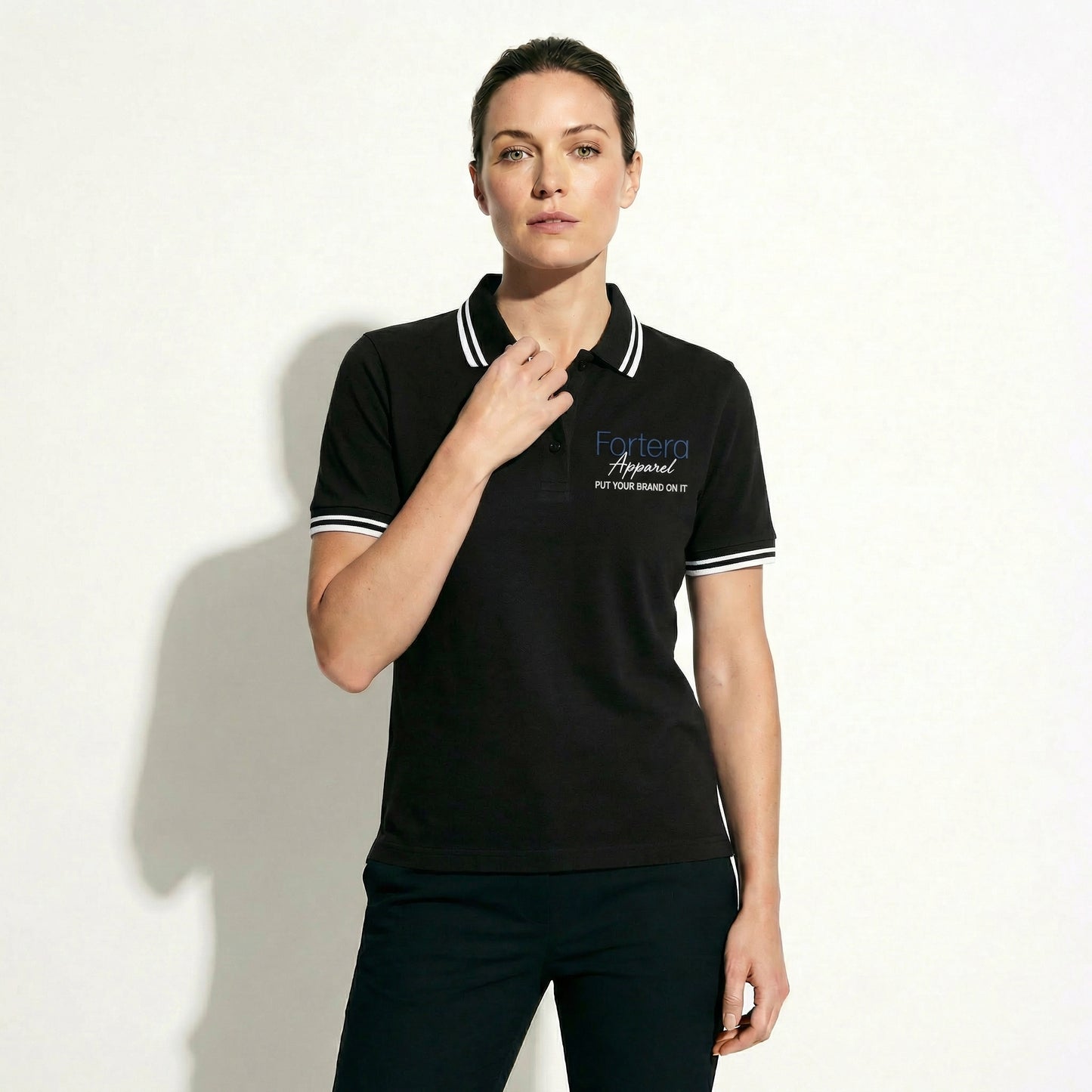All black classic polo shirt with white tipping on collar and cuffs - detail close-up