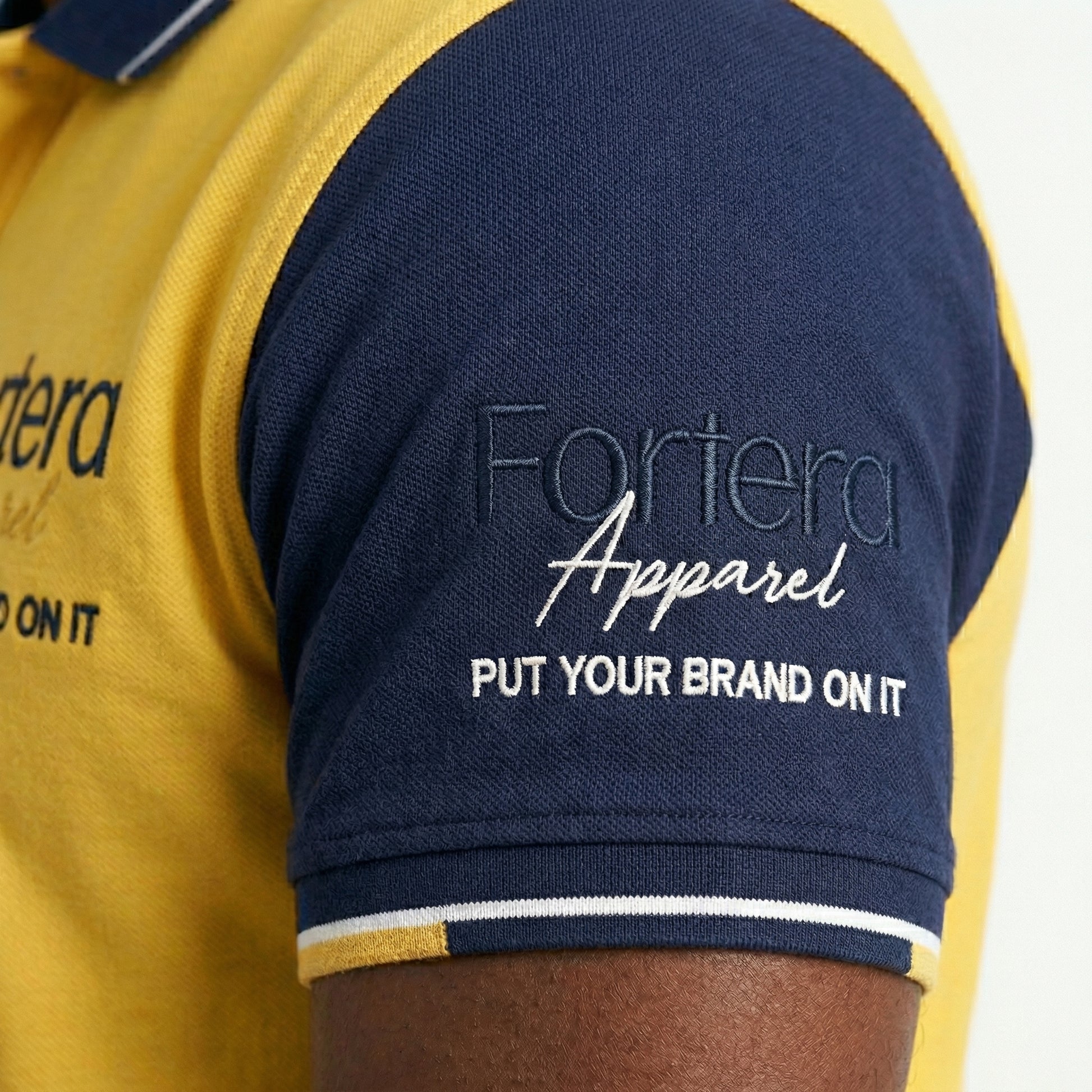 Yellow custom business polo shirt with navy shoulder panel and embroidered logo - team uniform group