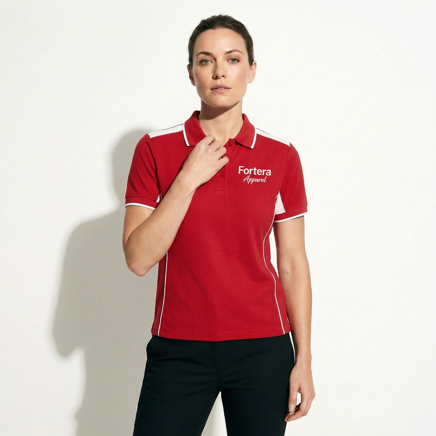 Red custom polo shirt with logo and white angular panel accent - female fit