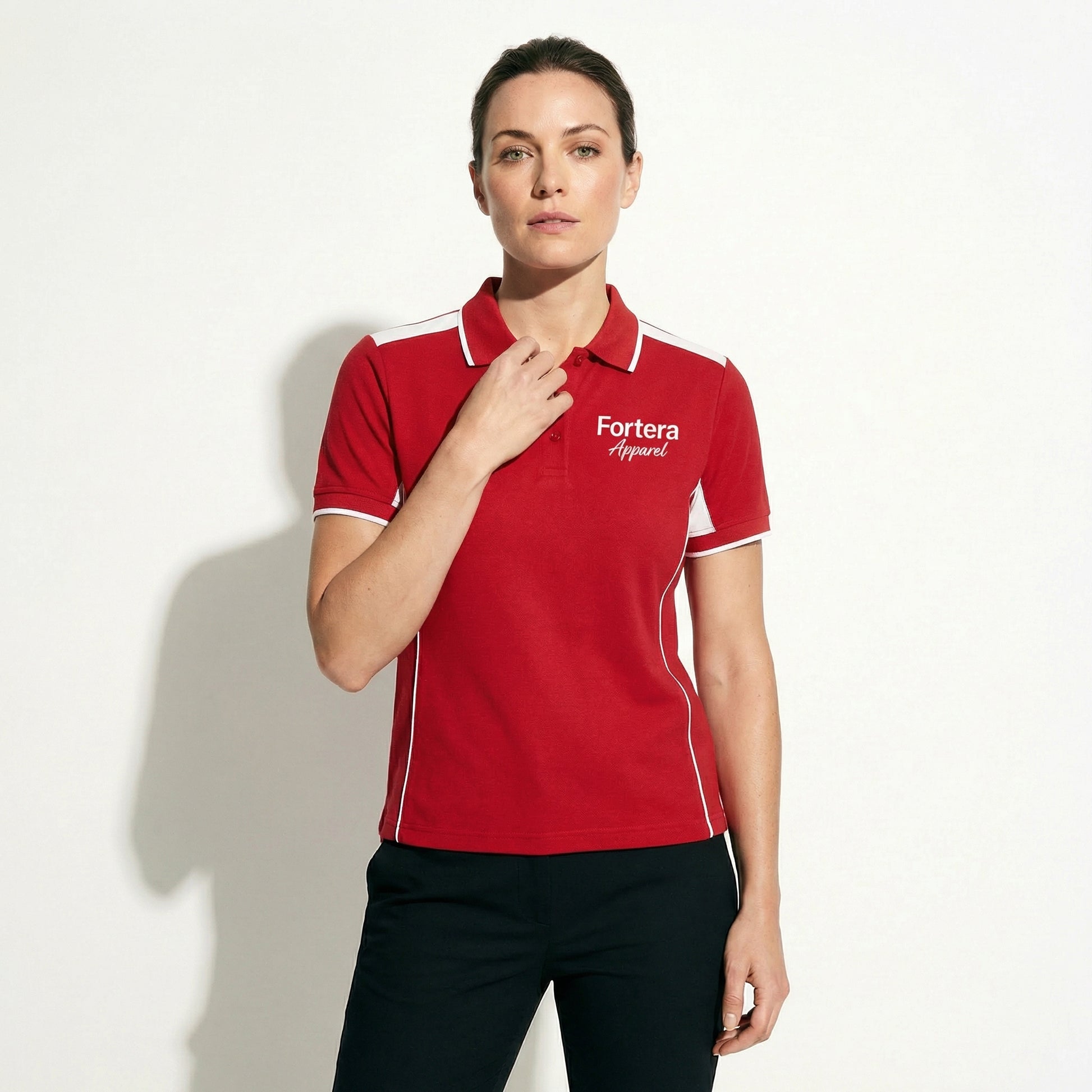 Red custom polo shirt with logo and white angular panel accent - female fit