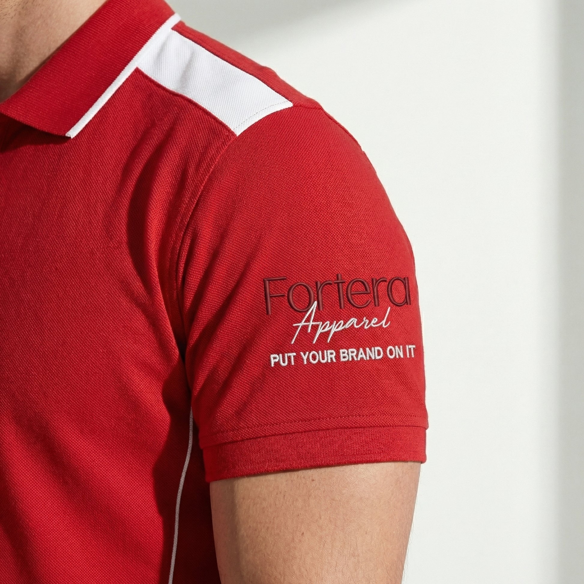 Red custom polo shirt with logo and white angular panel accent - team uniform group