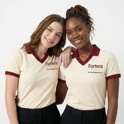 Cream custom staff polo shirt with burgundy heart collar V-neck accent - side view
