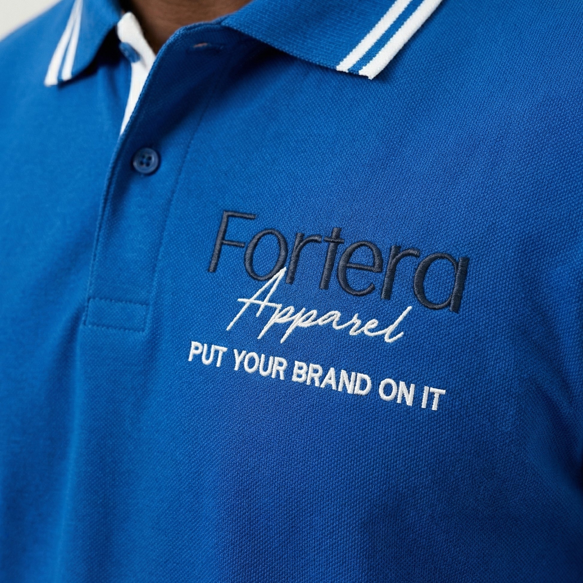 Royal blue custom staff polo shirt with white side panel and embroidered logo - male fit