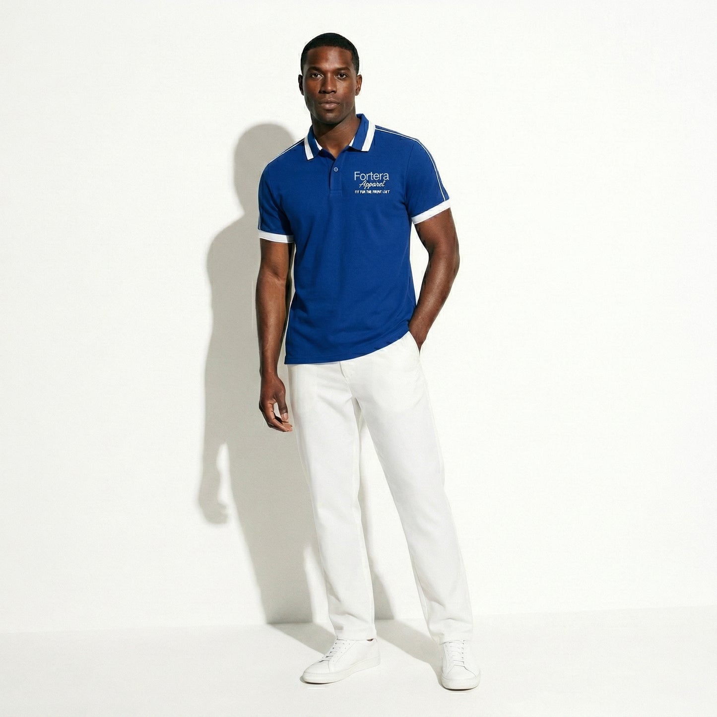 Royal blue embroidered polo shirt with white shoulder piping detail - detail close-up