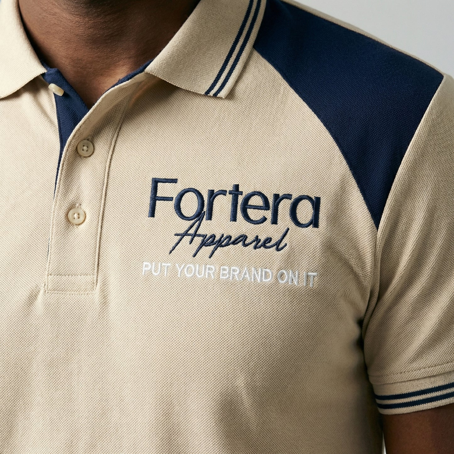 Beige embroidered polo shirt with navy yoke panel across shoulders - male fit