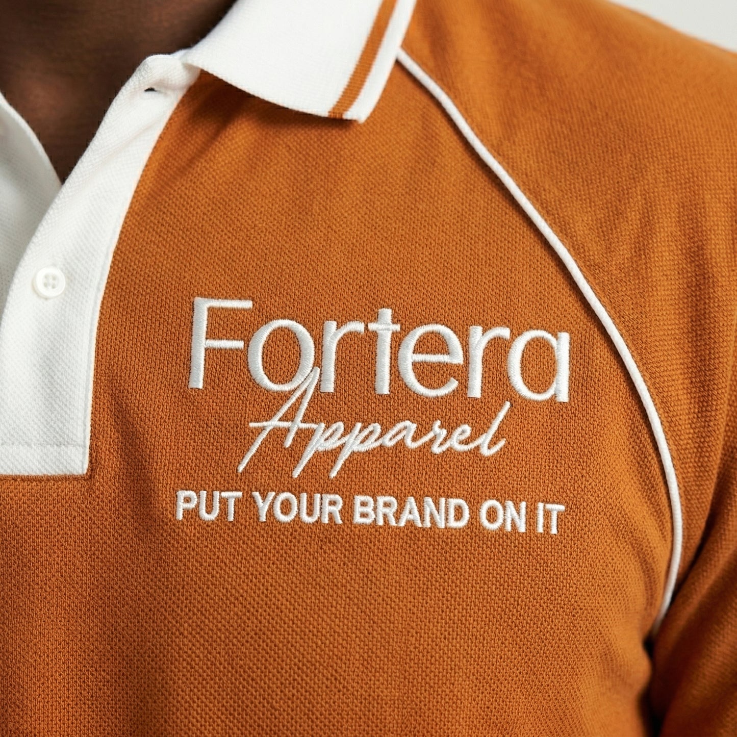 Orange moisture wicking polo uniform with white piping detail on collar and chest - male fit