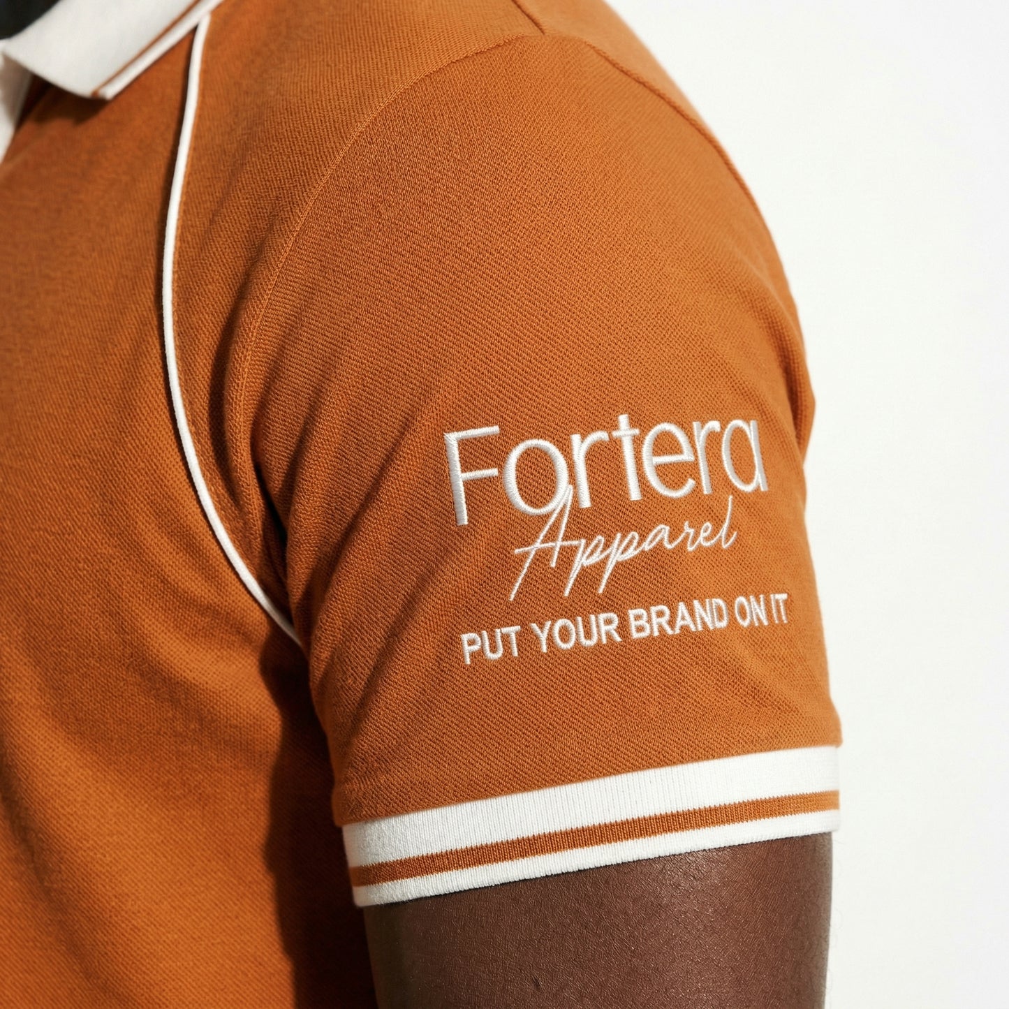 Orange moisture wicking polo uniform with white piping detail on collar and chest - team uniform group