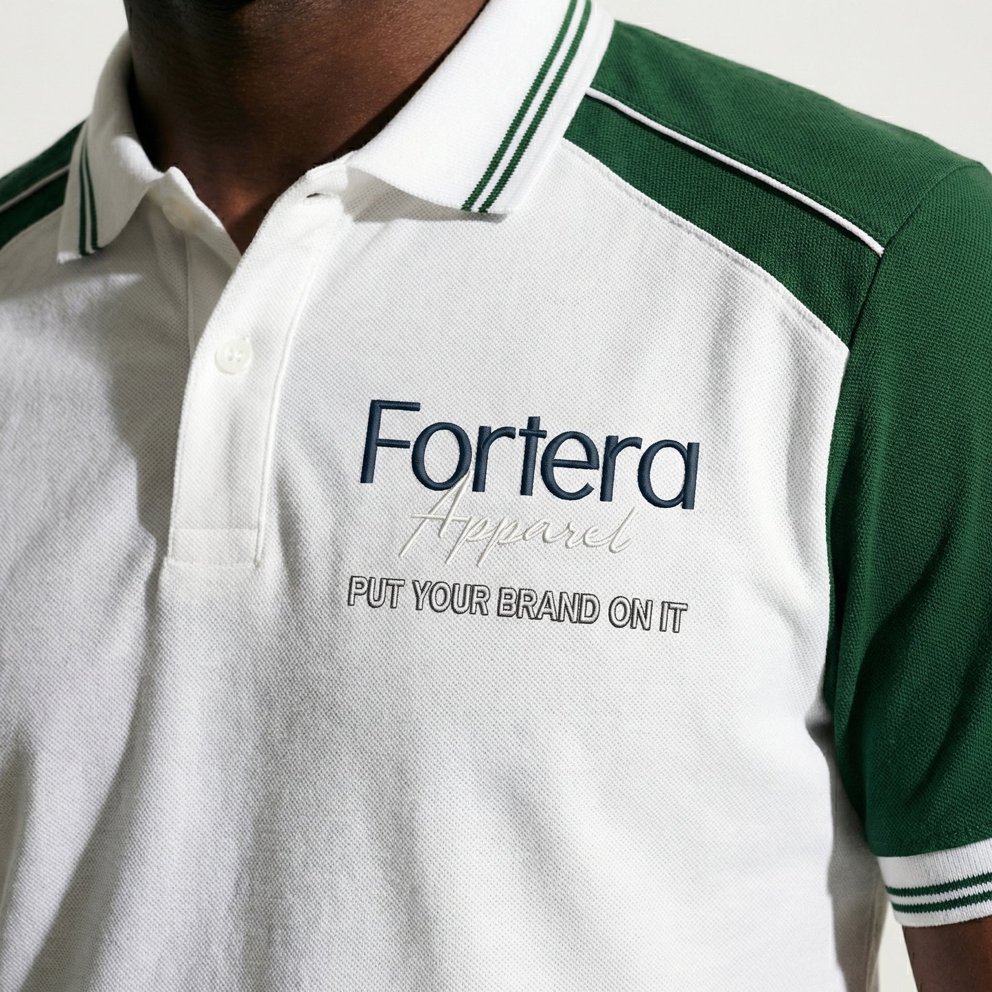 White moisture wicking polo uniform with forest green two-tone shoulder panel - male fit
