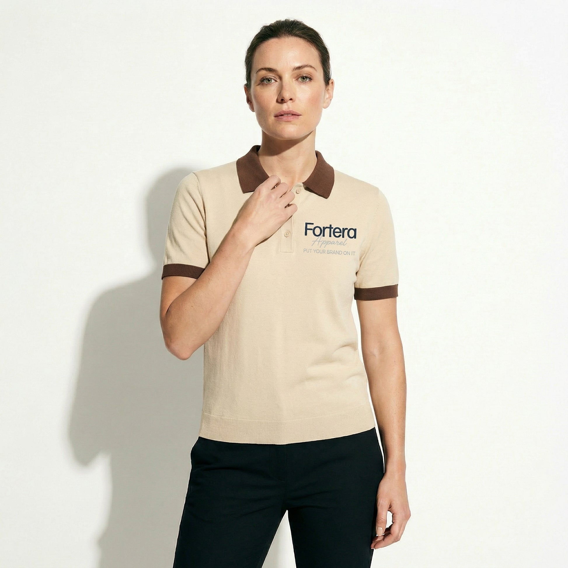 Beige polo shirt with company logo and dark brown contrast tipping on collar and cuffs - detail close-up