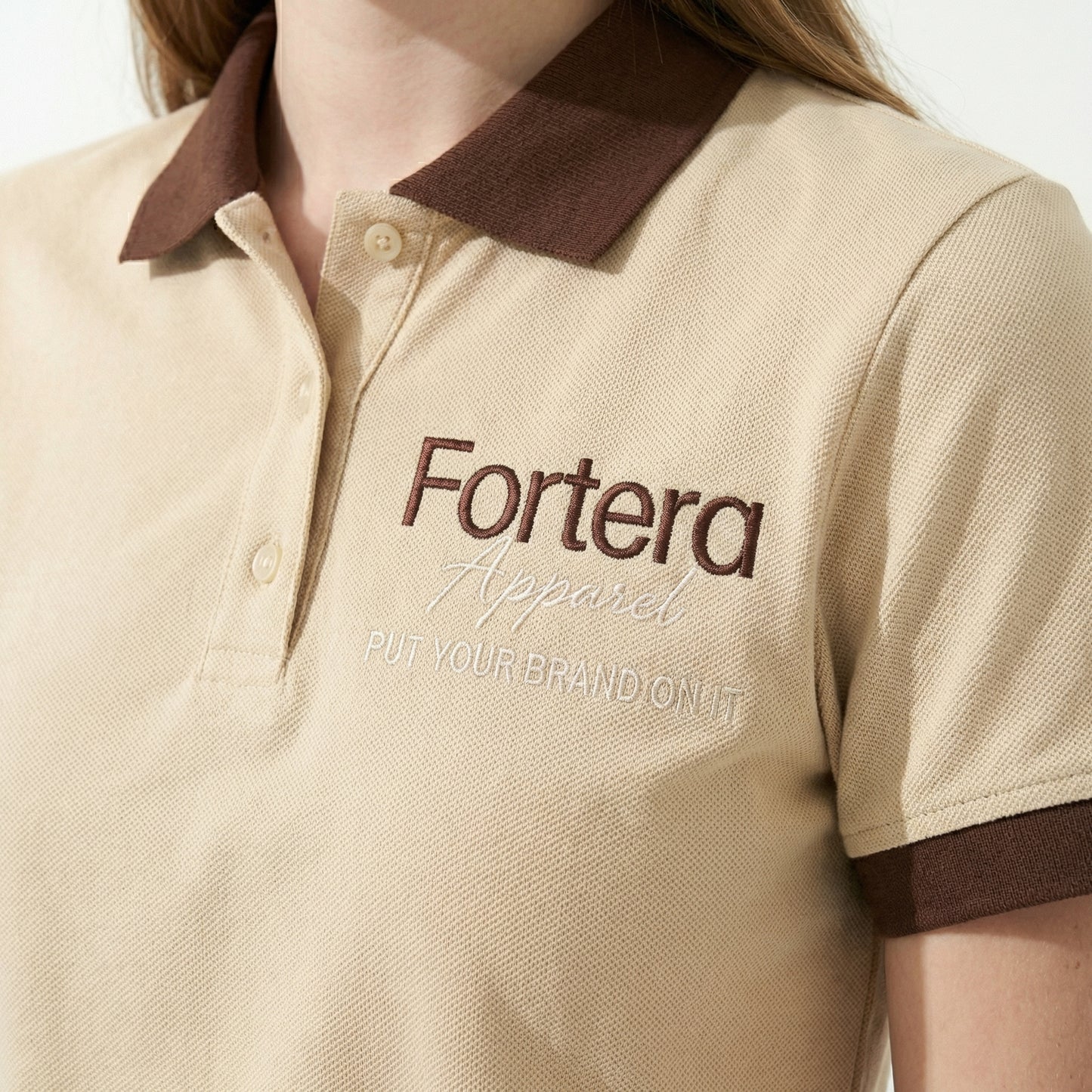 Beige polo shirt with company logo and dark brown contrast tipping on collar and cuffs - male fit