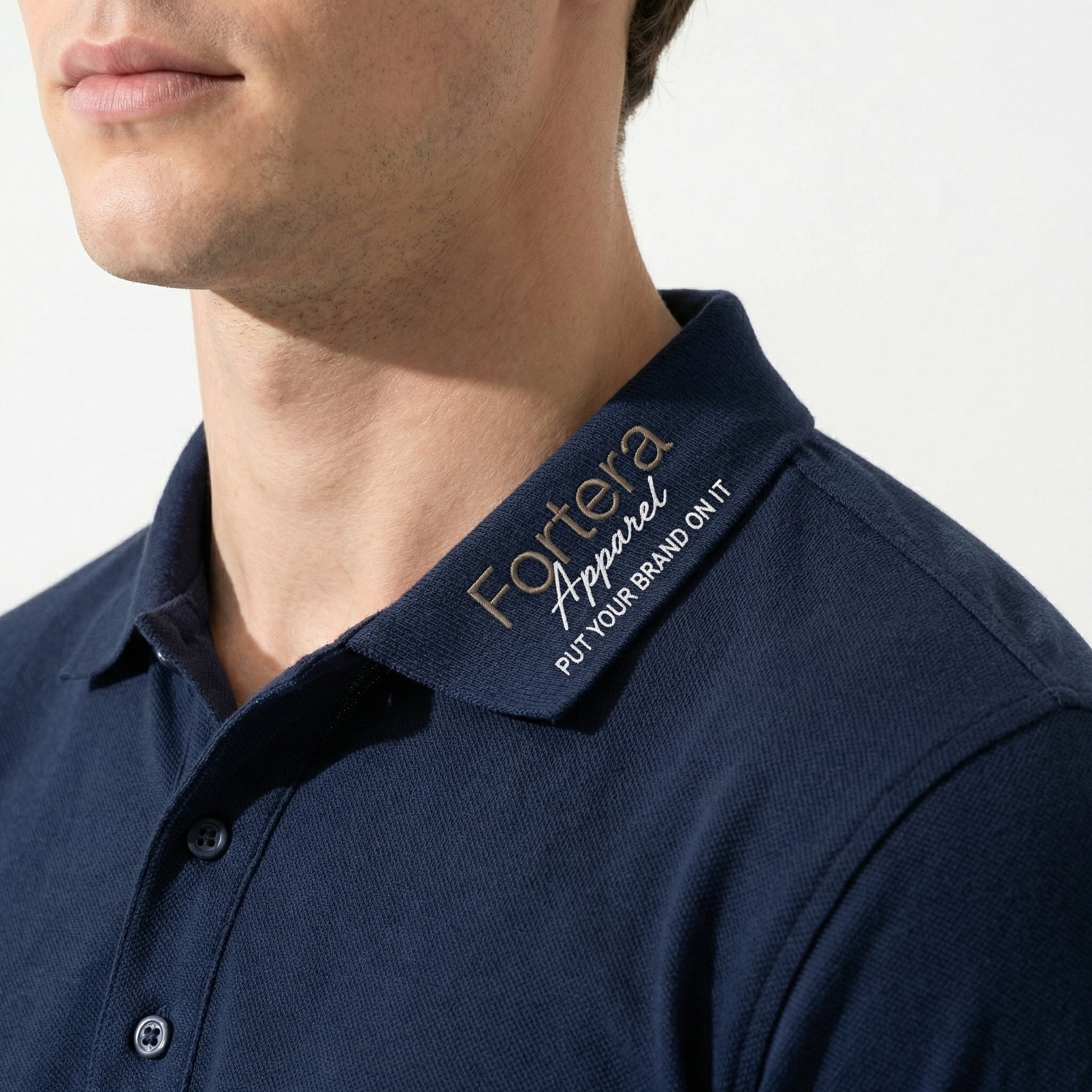 Solid navy custom embroidered polo shirt clean minimal design - logo embroidery detail