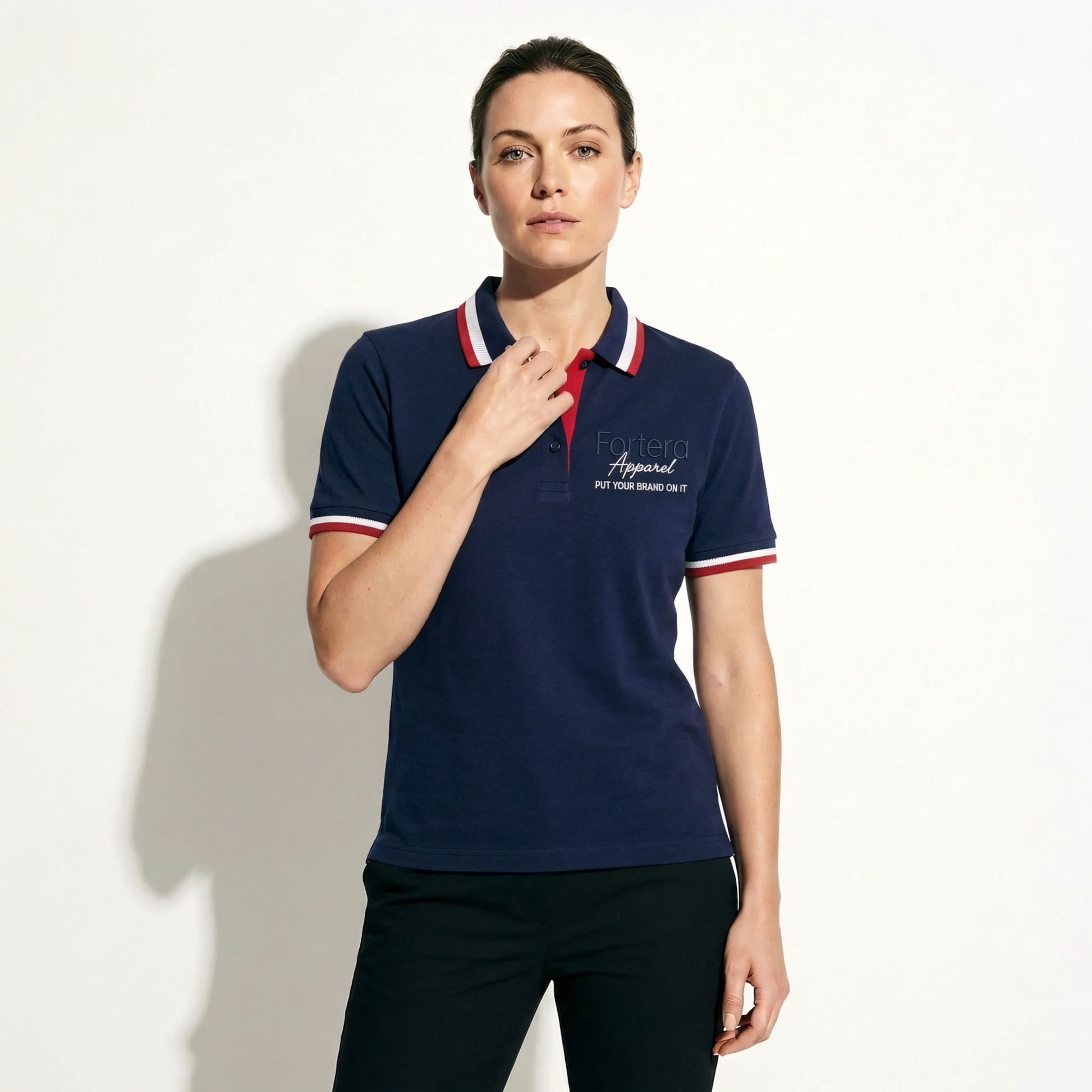Navy polo shirt with embroidered logo and red white stripe tipping on collar - detail close-up
