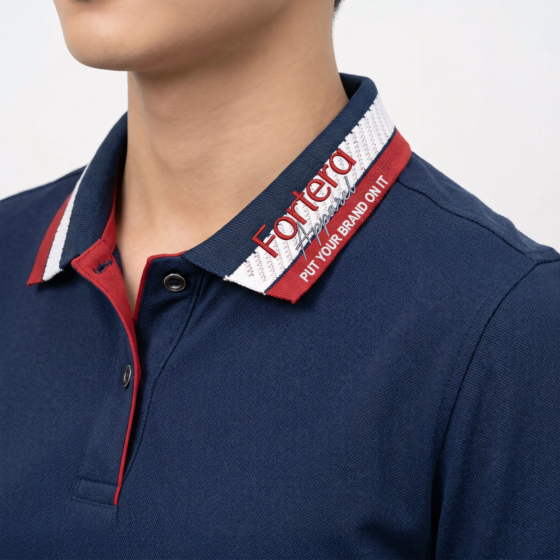 Navy polo shirt with embroidered logo and red white stripe tipping on collar - logo embroidery detail