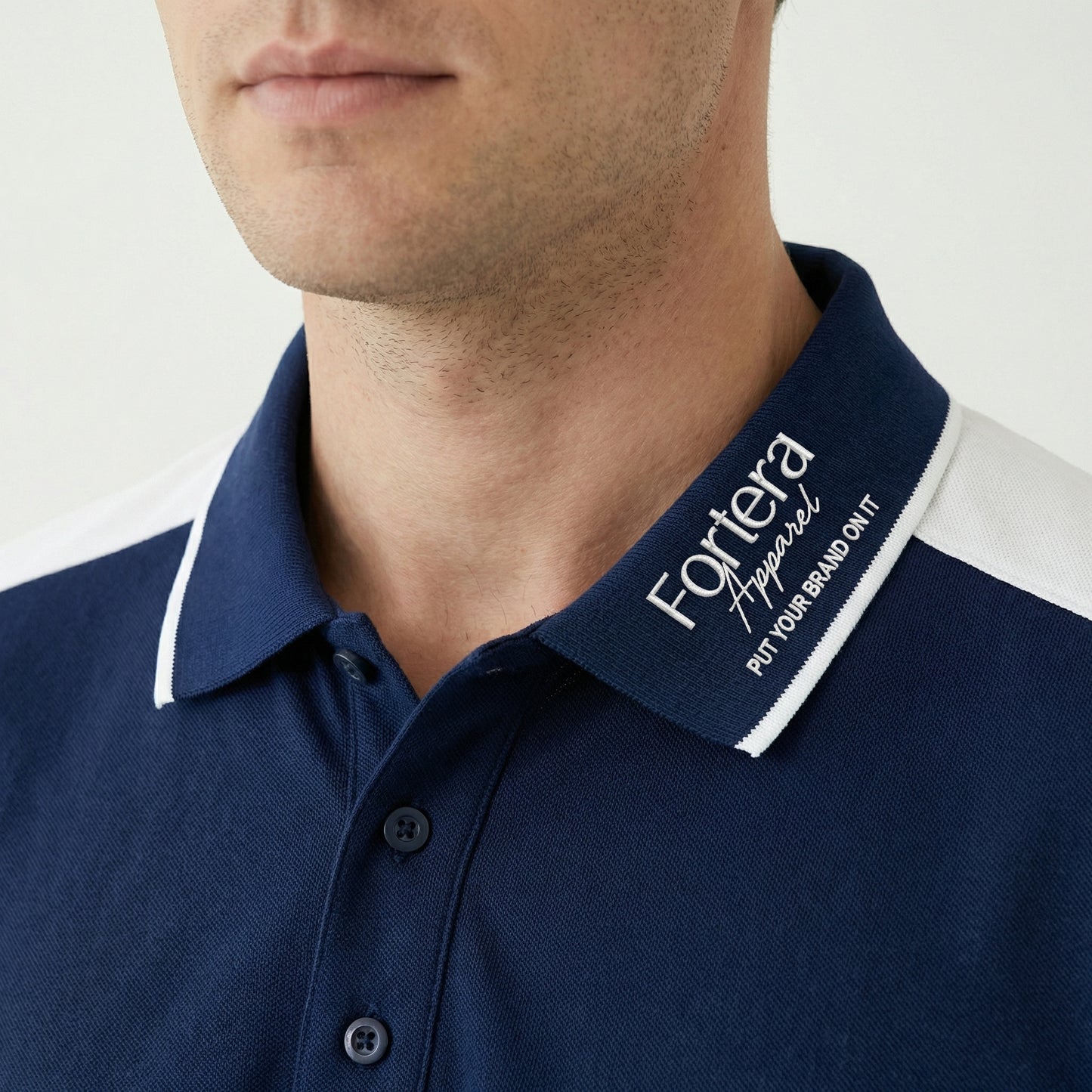 Navy work polo shirt with embroidered logo and white shoulder block panel - logo embroidery detail