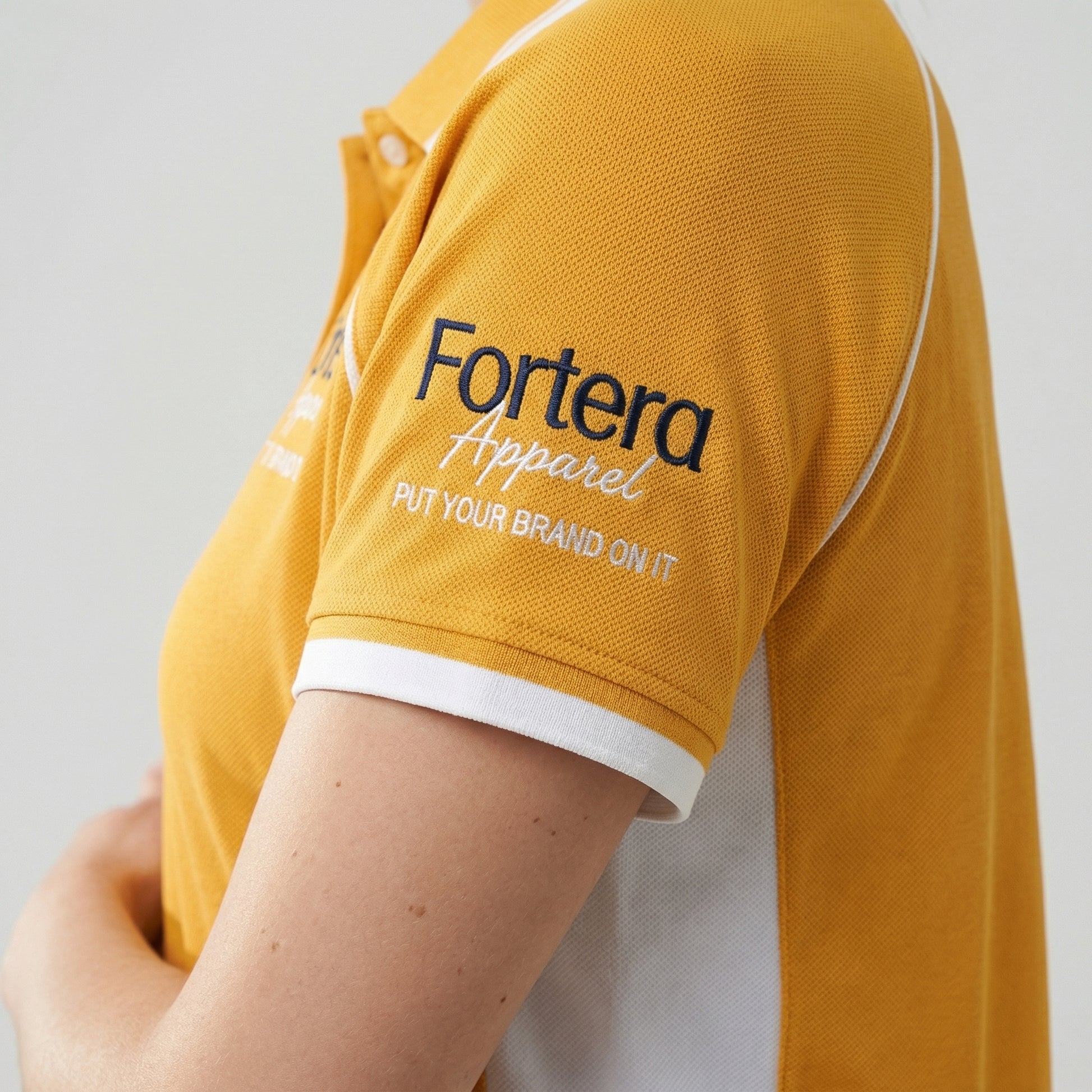 Amber yellow work polo shirt with embroidered logo and white shoulder panel - team uniform group